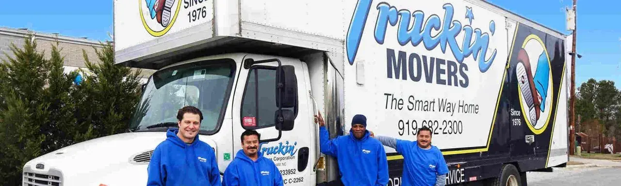 The Truckin' Movers crew with a moving truck in Durham, NC