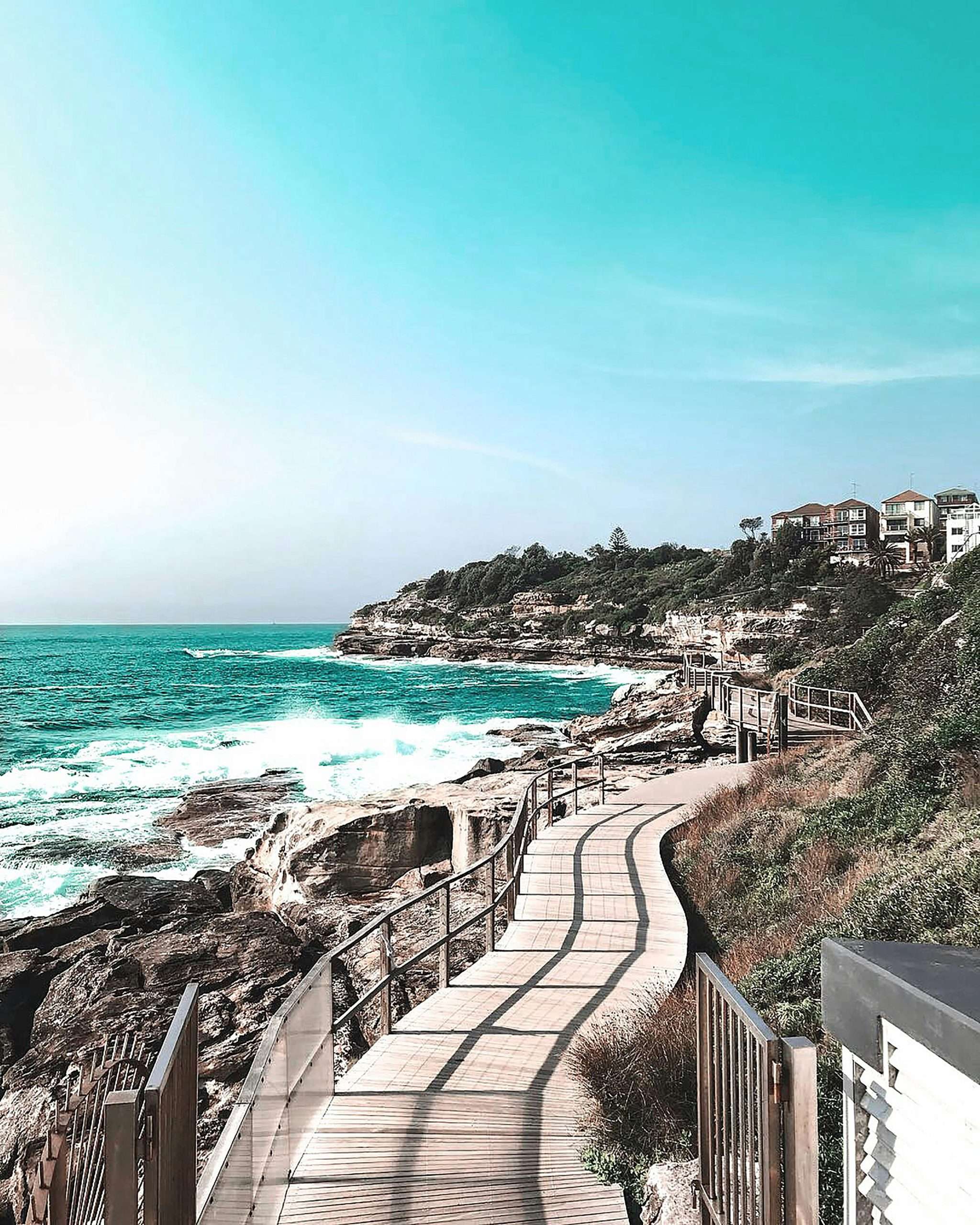pexels-vince-2265880 A wooden walkway extends towards the ocean