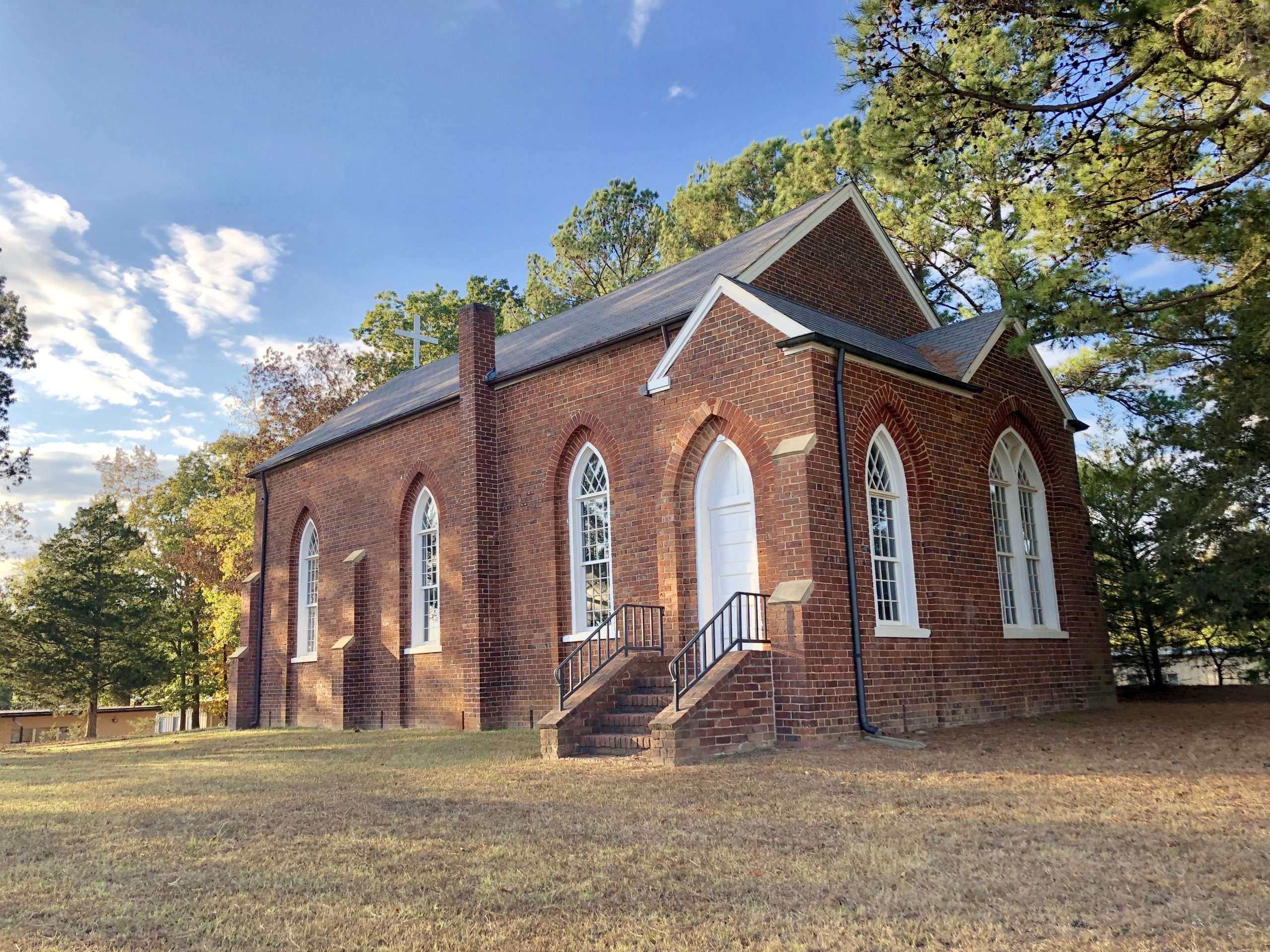 48976747803_65111ef0a6_o Historic brick church with arched windows and trees