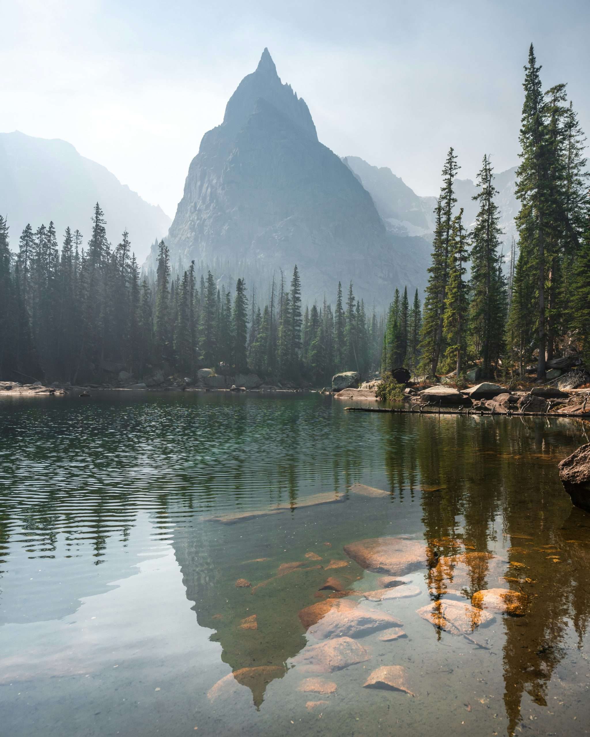 alyssa-teboda-8jnMX1EtFE4-unsplash Mountain peak reflected in a serene lake.