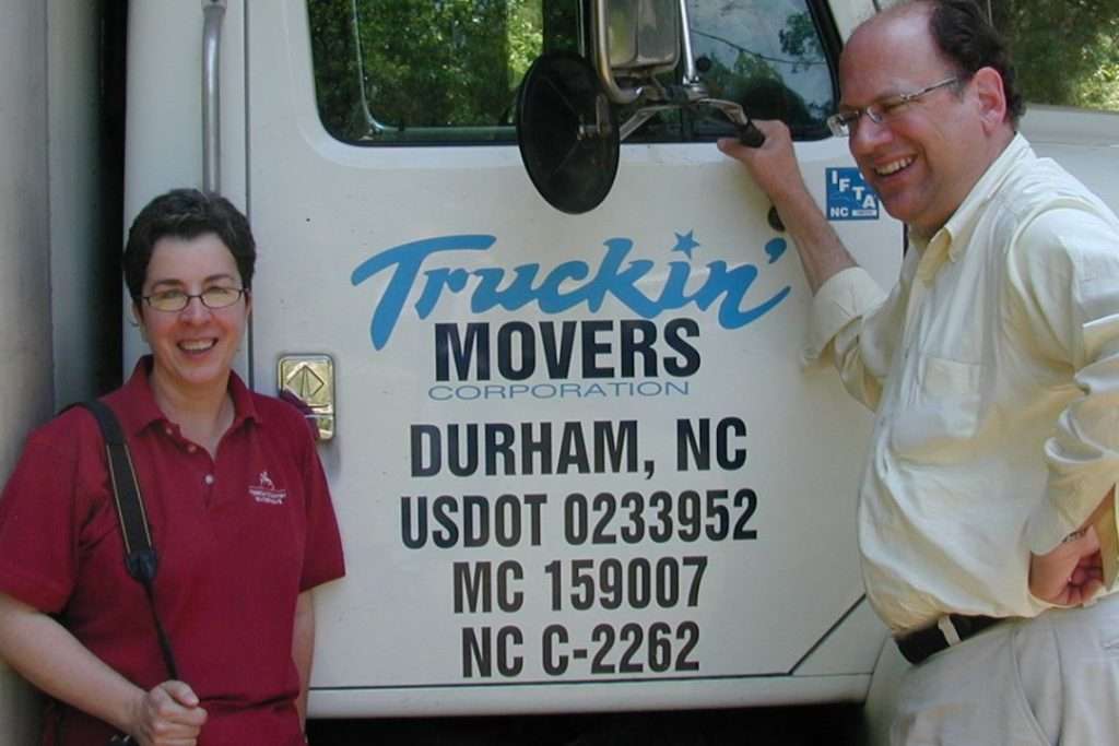Two people beside moving truck in Durham, NC.