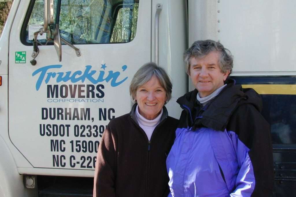 Couple beside a Truckin' Movers truck in Durham